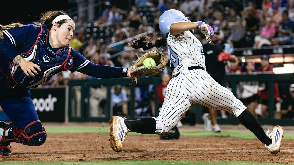 Portland Cascade catcher Mia Davidson reaches to tag Chicago Bandits runner Ailana Agbayani at Davis Diamond