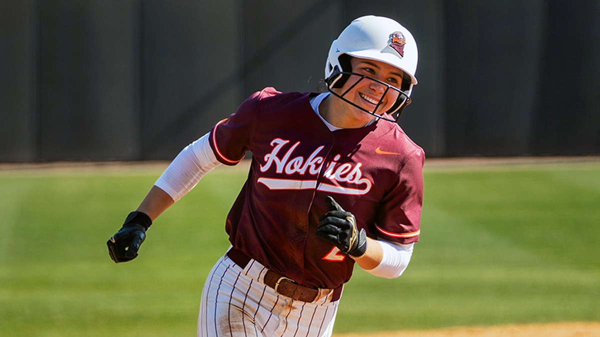 Virginia Tech's Cori McMillan smiles while running the bases