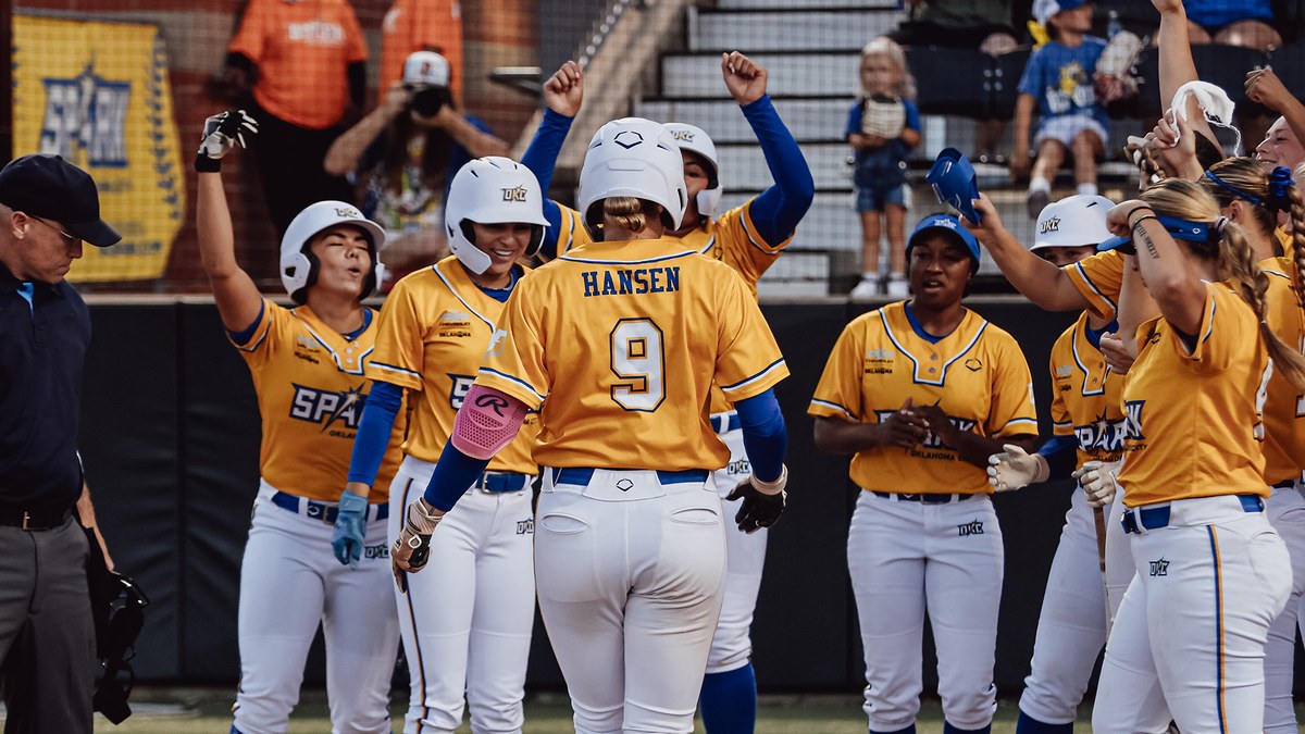 Oklahoma City Spark players greet a teammate at home plate