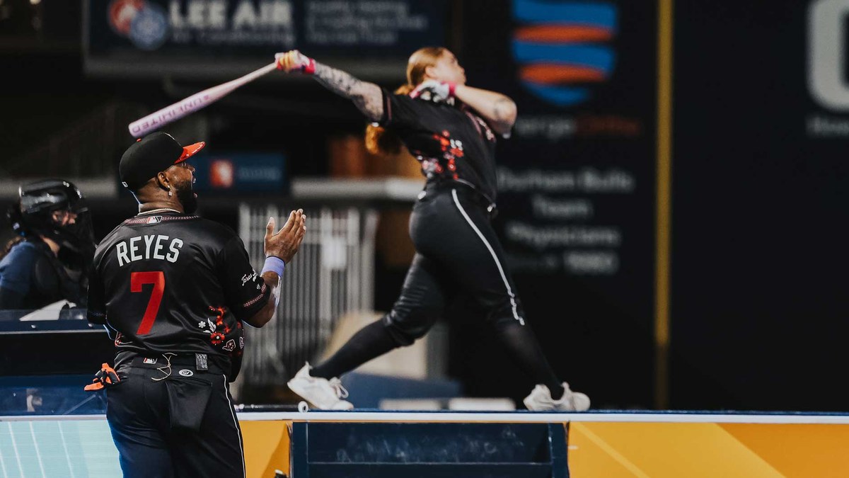 Portland Cascade slugger Megan Grant swings from the MLBx platform as José Reyes, No. 7, cheers at Durham Bulls Athletic Park