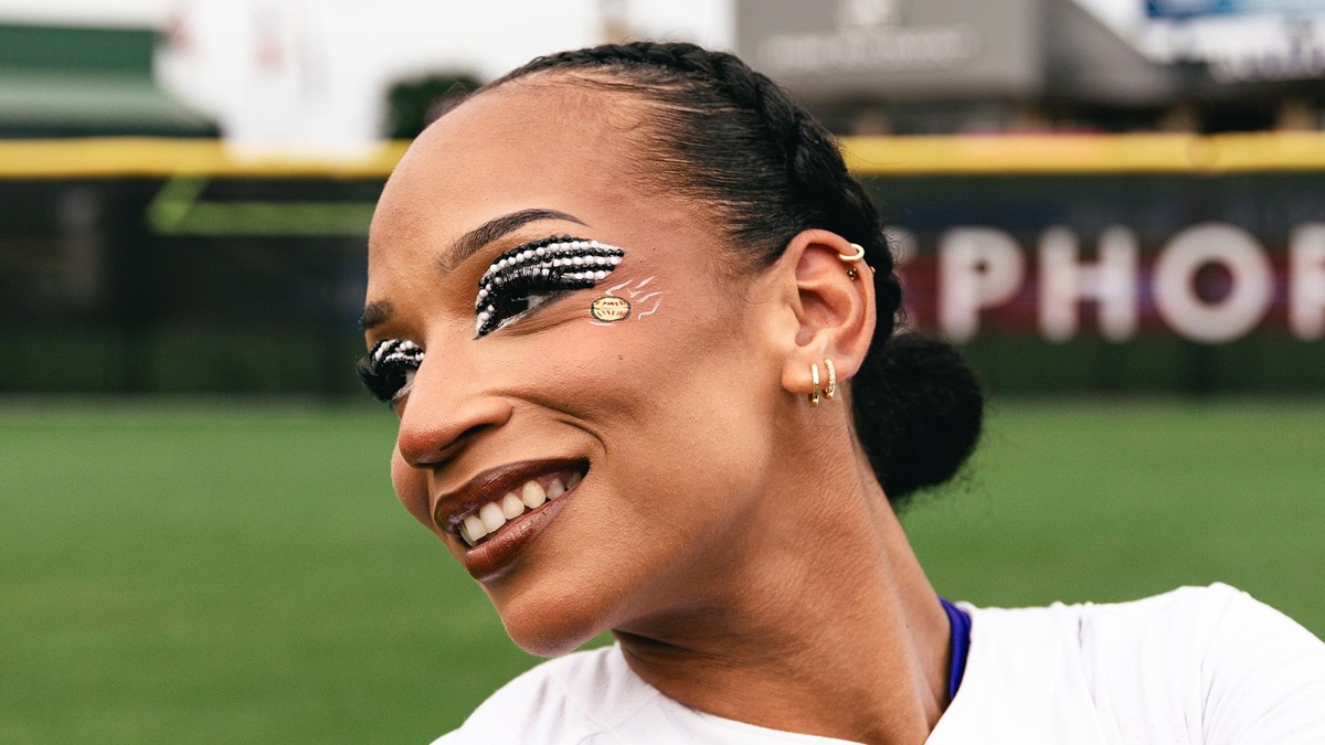 Texas Volts catcher Michaela Edenfield smiling on the field in black-and-white beaded eye makeup
