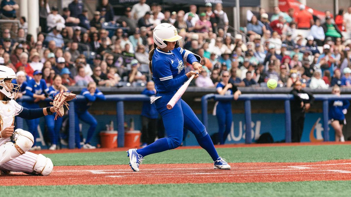 Oklahoma City Spark shortstop Sydney Romero swings at a pitch in an all-blue Spark uniform