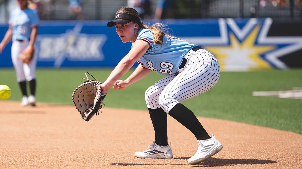 Chicago Bandits infielder Taryn Kern, No. 99, sets up to field a ground ball at first base in a powder blue uniform